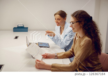 Two Professionals Actively Collaborating in a Modern and Innovative Office Space Environment Two Professionals Actively Collaborating in a Modern and Innovative Office Space Environment 126367164