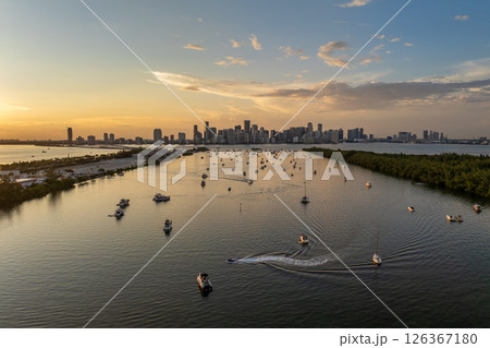 Miami, Florida. Biscayne Bay harbor near Virginia Key with yachts and sailboats at sunset. Urban skyline with high-rise buildings in downtown 126367180