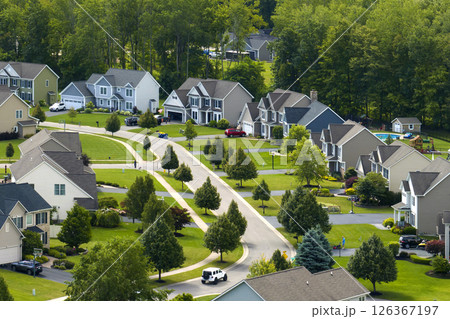 Low-density two story private homes with large lot size and green grassy lawns in summer season. Rural residential suburbs with upscale suburban houses outside of Rochester, New York Low-density two story private homes with large lot size and green grassy lawns in summer season. Rural residential suburbs with upscale suburban houses outside of Rochester, New York 126367197