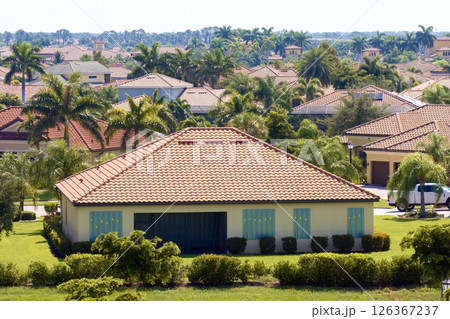 Hurricane shutters made from steel mounted for protection of house windows. Protective measures before natural disaster in Florida Hurricane shutters made from steel mounted for protection of house windows. Protective measures before natural disaster in Florida 126367237