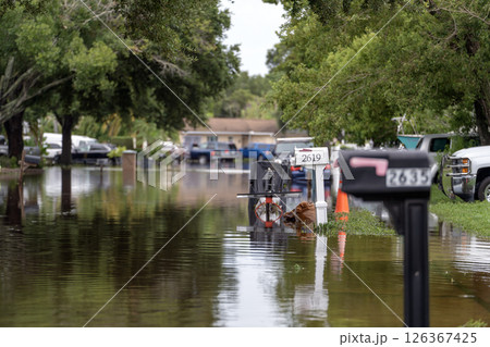 Hurricane flooded street with mail box surrounded with water in Florida residential area. Consequences of natural disaster 126367425