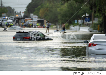 Hurricane flooded cars on city street in surrounded with water Florida residential area. Consequences of hurricane Debby natural disaster Hurricane flooded cars on city street in surrounded with water Florida residential area. Consequences of hurricane Debby natural disaster 126367428