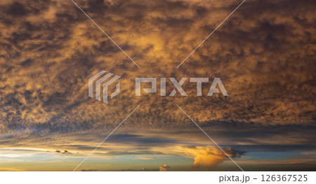 Getting dark at sundown. Sunset sky with scattered clouds of bright colors 126367525