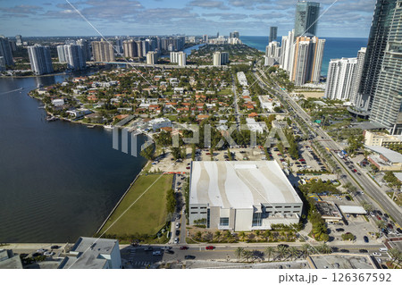 Expensive highrise hotels and condos on Atlantic ocean shore in Sunny Isles Beach city and busy street traffic. American tourism infrastructure in southern Florida 126367592