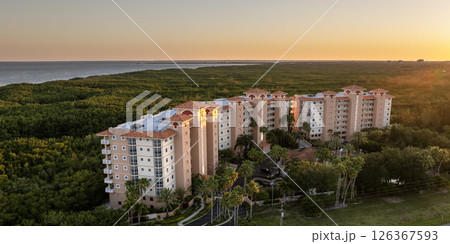 Expensive apartment building in Florida quiet nature area. Family housing in suburban neighborhood. Real estate development in American suburbs Expensive apartment building in Florida quiet nature area. Family housing in suburban neighborhood. Real estate development in American suburbs 126367593