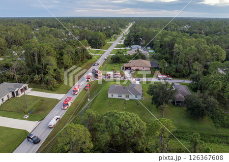 Emergency service personnel responding to potential fire hazard at Florida home. First responders ready to extinguish fire of burning house Emergency service personnel responding to potential fire hazard at Florida home. First responders ready to extinguish fire of burning house 126367608