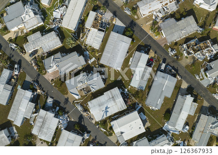 Consequences of natural disaster in Florida, USA. Aerial view of heavily damaged by hurricane Ian houses in mobile home residential area 126367933