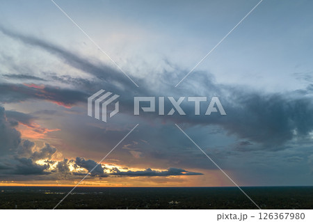 Colofrul clouds brightly illuninated by setting sun on evening sky. Changing cloudscape weather at sunset 126367980