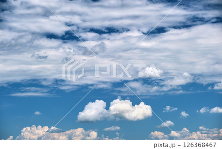 Bright landscape of white puffy cumulus clouds on blue clear sky. Bright landscape of white puffy cumulus clouds on blue clear sky. 126368467