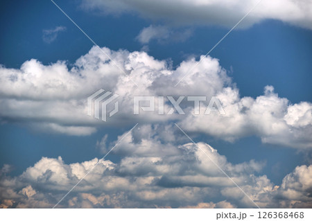 Bright landscape of white puffy cumulus clouds on blue clear sky. 126368468