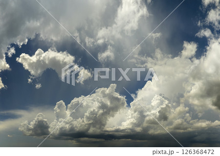 Bright landscape of blue sky with flying white clouds. Colorful summer skyscape 126368472