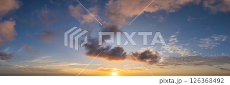Beautiful sunset sky scenery. Bright colorful orange and yellow clouds on horizon Beautiful sunset sky scenery. Bright colorful orange and yellow clouds on horizon 126368492