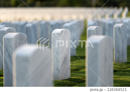 American national military cemetery with rows of white tomb stones on green grass lawn. Memorial Day concept American national military cemetery with rows of white tomb stones on green grass lawn. Memorial Day concept 126368521