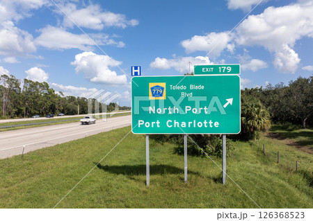 American interstate highway directional exit sign on fast motorway in Florida, USA. I-75 freeway junction leading to North Port and Port Charlotte 126368523