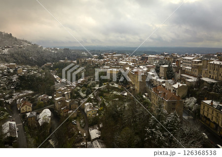 Aerial winter landscape of dense historic center of Thiers town in Puy-de-Dome department, Auvergne-Rhone-Alpes region in France. Rooftops of old buildings and narrow streets at snowfall Aerial winter landscape of dense historic center of Thiers town in Puy-de-Dome department, Auvergne-Rhone-Alpes region in France. Rooftops of old buildings and narrow streets at snowfall 126368538