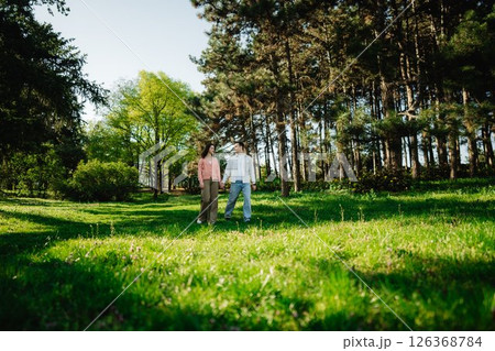 Exploring nature together in a serene forest during a sunny day Exploring nature together in a serene forest during a sunny day 126368784