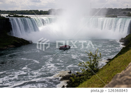 Tour Boat Navigating the Misty Waters of Niagara Falls Horseshoe Falls 126368843
