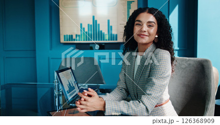 Portrait, smile and business woman with laptop for finance, investment metrics and data with actuary. Computer, corporate professional and happy employee in office with confidence as risk analyst 126368909