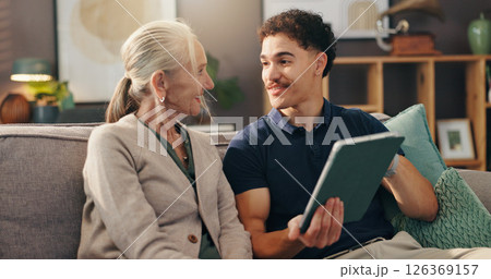 Senior woman, nurse and tablet on couch, happy and report for wellness in living room at apartment. Caregiver, elderly person and digital touchscreen for health, application and results in retirement 126369157