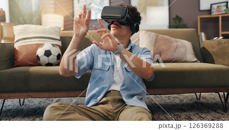 Simulation, gamer and man with vr headset, home and 3D virtual reality with tech for games and lounge. House, player and person with eyewear for entertainment, user experience and fantasy with web 126369288