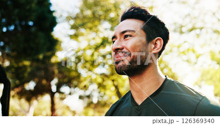 Man, smile and thinking with low angle in park, peace or calm with happy reflection, memory or future. Hope, mindfulness and male person pondering in nature, space and healthy mindset outdoor 126369340