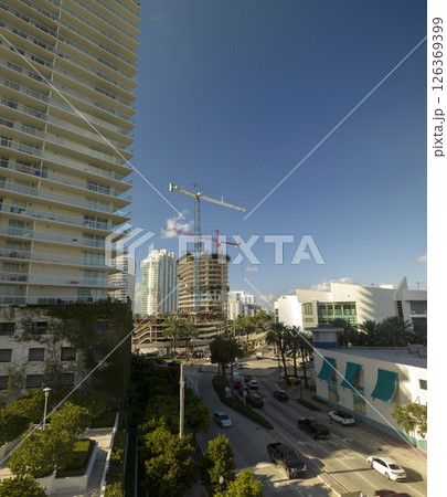 Aerial view of new developing residense in american urban area. Tower cranes at industrial construction site in Miami, Florida. Concept of housing growth in the USA 126369399