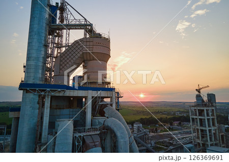 Aerial view of cement factory with high concrete plant structure and tower crane at industrial production site. Manufacture and global industry concept Aerial view of cement factory with high concrete plant structure and tower crane at industrial production site. Manufacture and global industry concept 126369691