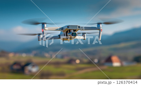 Flying Drone with Camera Capturing Aerial View of Countryside 126370414