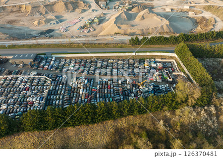 Aerial view of big parking lot of junkyard with rows of discarded broken cars. Recycling of old vehicles 126370481