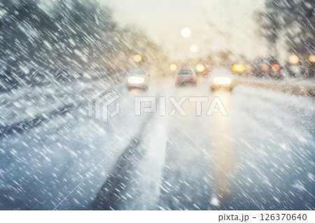 traffic on the background of a snowstorm in winter, a snow-covered road, safety concept on a slippery road 126370640