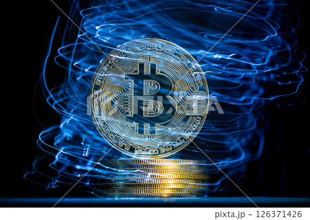 Bitcoin cryptocurrency coin hovering over a stack of coins with futuristic blue lights emanating from the surface, creating a dynamic visual representation of digital finance and investment Bitcoin cryptocurrency coin hovering over a stack of coins with futuristic blue lights emanating from the surface, creating a dynamic visual representation of digital finance and investment 126371426
