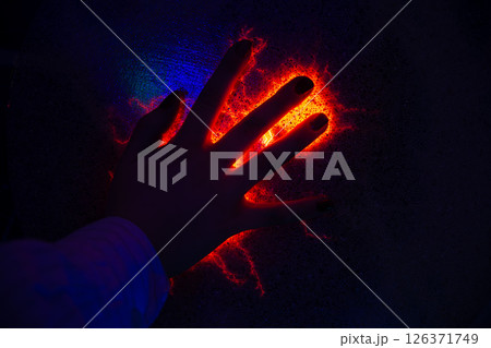 Orange plasma filaments reaching out to a child's hand interacting with a plasma ball exhibit, creating a mesmerizing display of electricity and scientific wonder Orange plasma filaments reaching out to a child's hand interacting with a plasma ball exhibit, creating a mesmerizing display of electricity and scientific wonder 126371749
