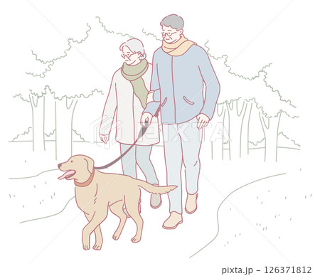A couple is joyfully walking their dog together in the beautiful, peaceful nature 126371812