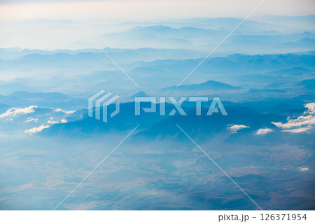 A view of the planet Earth, a view from an airplane, mountains and clouds A view of the planet Earth, a view from an airplane, mountains and clouds 126371954
