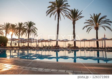 beach umbrellas, sun loungers by the pool, rest, relax, summer vacation beach umbrellas, sun loungers by the pool, rest, relax, summer vacation 126371969