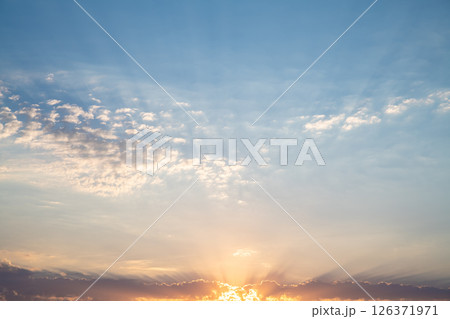 Beautiful sunset or sunrise, sky with clouds, sun rays breaking through the clouds, magical, fabulous natural background, serenity and calm Beautiful sunset or sunrise, sky with clouds, sun rays breaking through the clouds, magical, fabulous natural background, serenity and calm 126371971