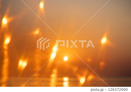 Beautiful sunset or sunrise on the sea, clear sky, natural delicate background with beautiful highlights, sky and sun at sunrise 126372000