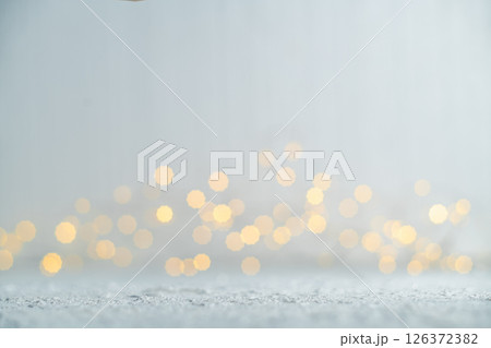 Blurring golden christmas lights against a shimmering silver background creates a magical and festive atmosphere, perfect for celebrating the holiday season with warmth and joy Blurring golden christmas lights against a shimmering silver background creates a magical and festive atmosphere, perfect for celebrating the holiday season with warmth and joy 126372382