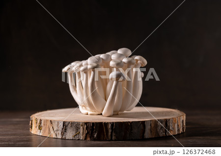 Closeup of a bunch of shimeji mushrooms on wooden background, with selective focus Closeup of a bunch of shimeji mushrooms on wooden background, with selective focus 126372468