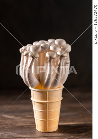 Closeup of a bunch of shimeji mushrooms on wooden background, with selective focus 126372470