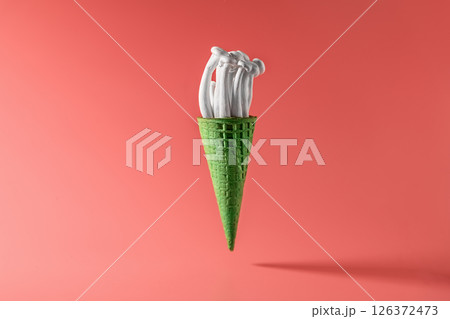 shimeji mushrooms in green ice cream cone, on pink background 126372473