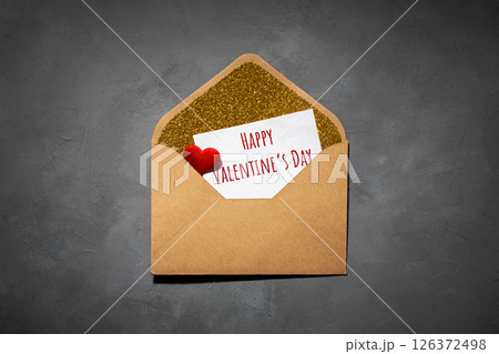 envelope with paper inside, with the text happy valentines day, on grey concrete background envelope with paper inside, with the text happy valentines day, on grey concrete background 126372498