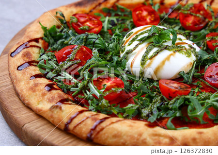 Burrata Arugula Pizza with Cherry Tomatoes Pesto and Balsamic Drizzle Burrata Arugula Pizza with Cherry Tomatoes Pesto and Balsamic Drizzle 126372830