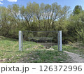 Metal Fence Gate Blocking Small Footbridge in Forested Area 126372996