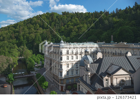 Tepla river flowing through Karlovy Vary with Hotel in background. Czech Republic Tepla river flowing through Karlovy Vary with Hotel in background. Czech Republic 126373421