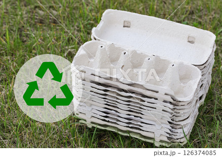 Empty Egg Cartons, Paper Container on Green Grass background. Recycling Concept Empty Egg Cartons, Paper Container on Green Grass background. Recycling Concept 126374085