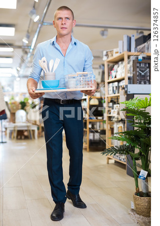 Man choosing accessories in shop for decor 126374857