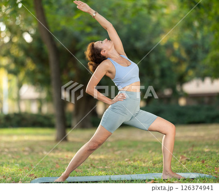 Adult woman doing yoga in park 126374941