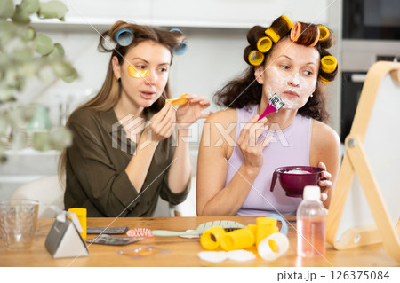 Female friends enjoying moments of beauty routine at home Female friends enjoying moments of beauty routine at home 126375084