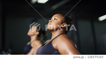 Plus size woman lifting dumbbells and training indoors at the gym, showcasing strength and determination. Generated image 126375103